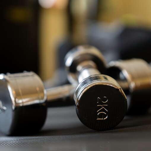 Zwei Hanteln (2 kg) liegen auf einer Matte