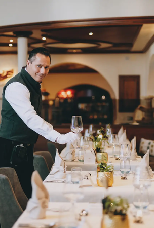 Kellner deckt Tisch im Hotel Tyrol am Haldensee